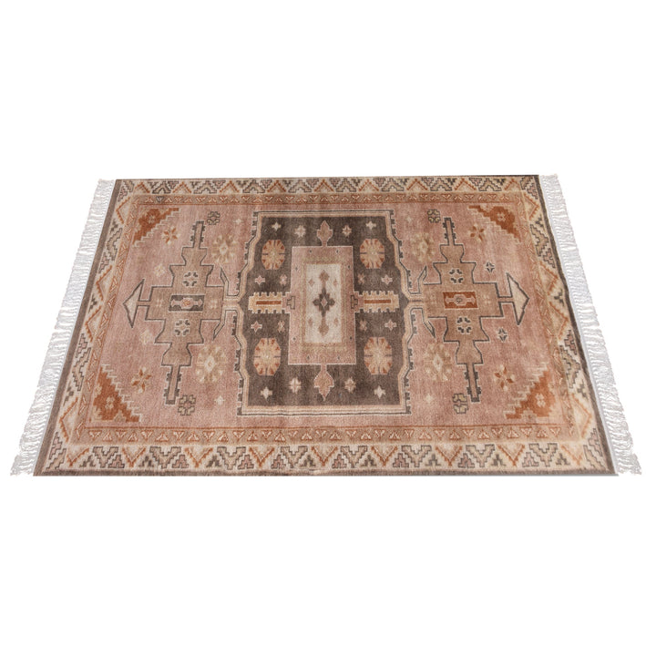 Matka hand-knotted wool rug with a faded terracotta Persian medallion, navy and brown, in a bedroom