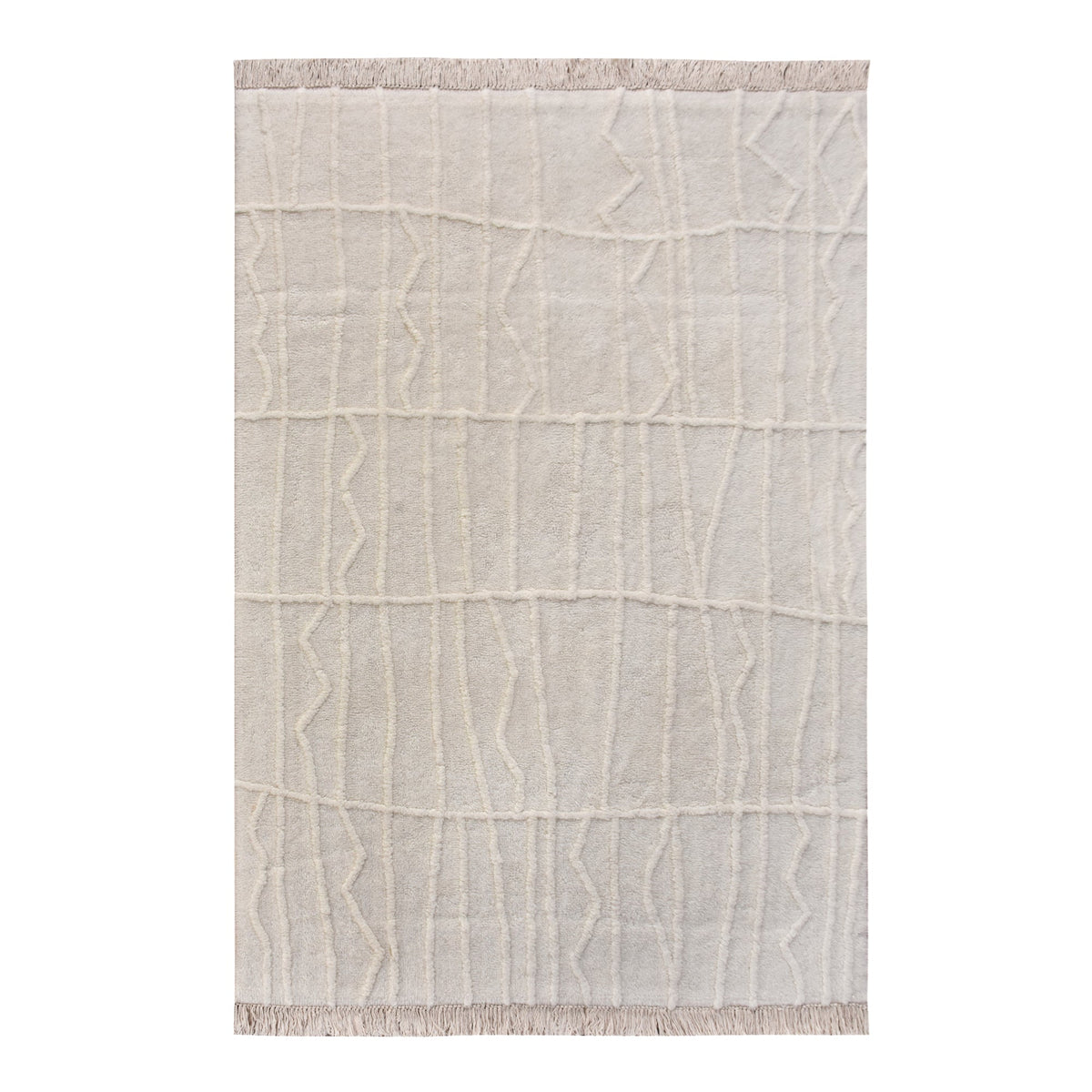 Swell tufted ivory New Zealand wool rug with carved waves and fringe, in a living room