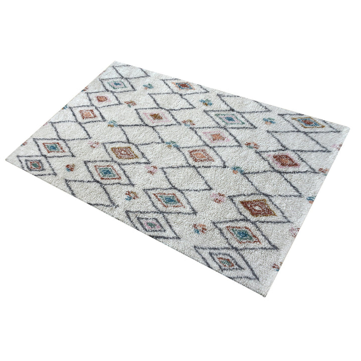 Mela tufted New Zealand wool rug with an ivory lattice and rust, teal and charcoal diamonds
