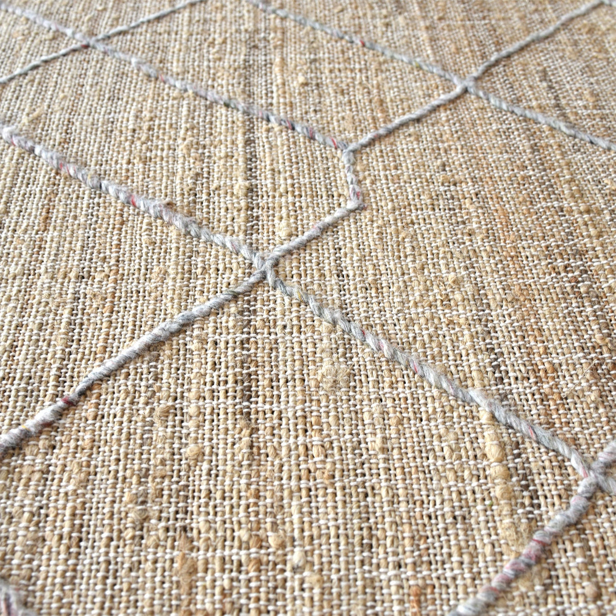 Trellis handwoven hemp and wool rug with fine diamond lattice on natural, in a living room