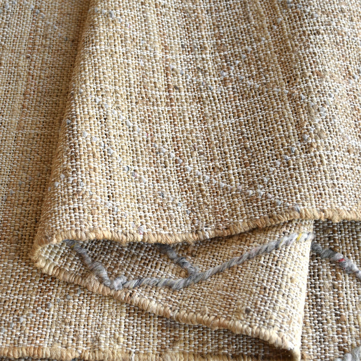 Trellis handwoven hemp and wool rug with fine diamond lattice on natural, in a living room