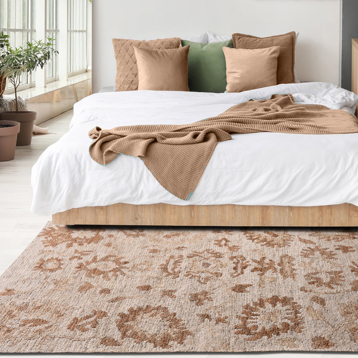 Peony hand-knotted ivory jute rug with faded terracotta florals, in a living room