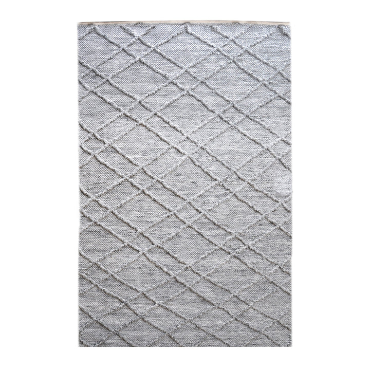 Razai handwoven recycled PET rug with a taupe diamond-quilted raised weave, on a patio