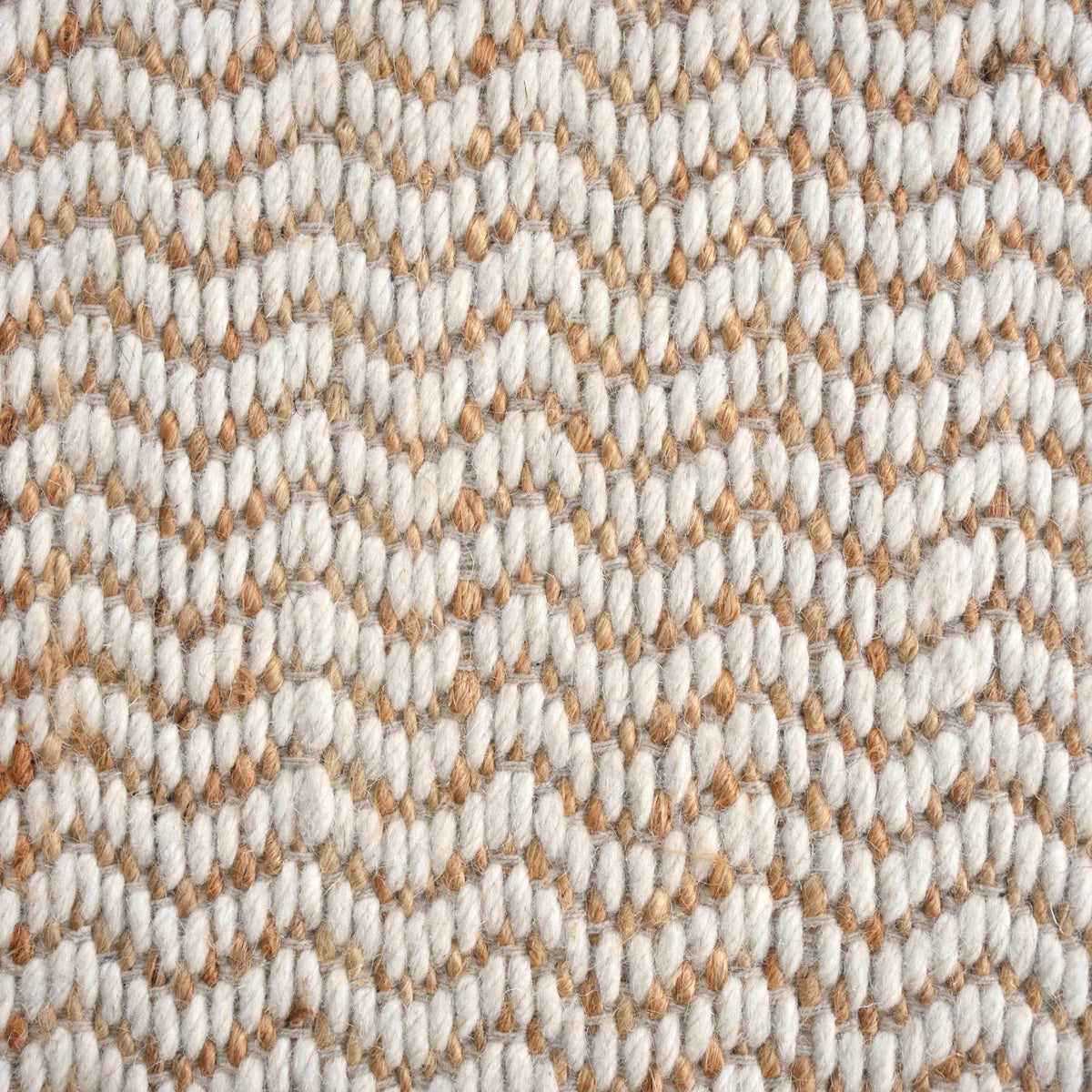 Chevron handwoven cream wool and jute rug with a herringbone chevron weave, in a living room