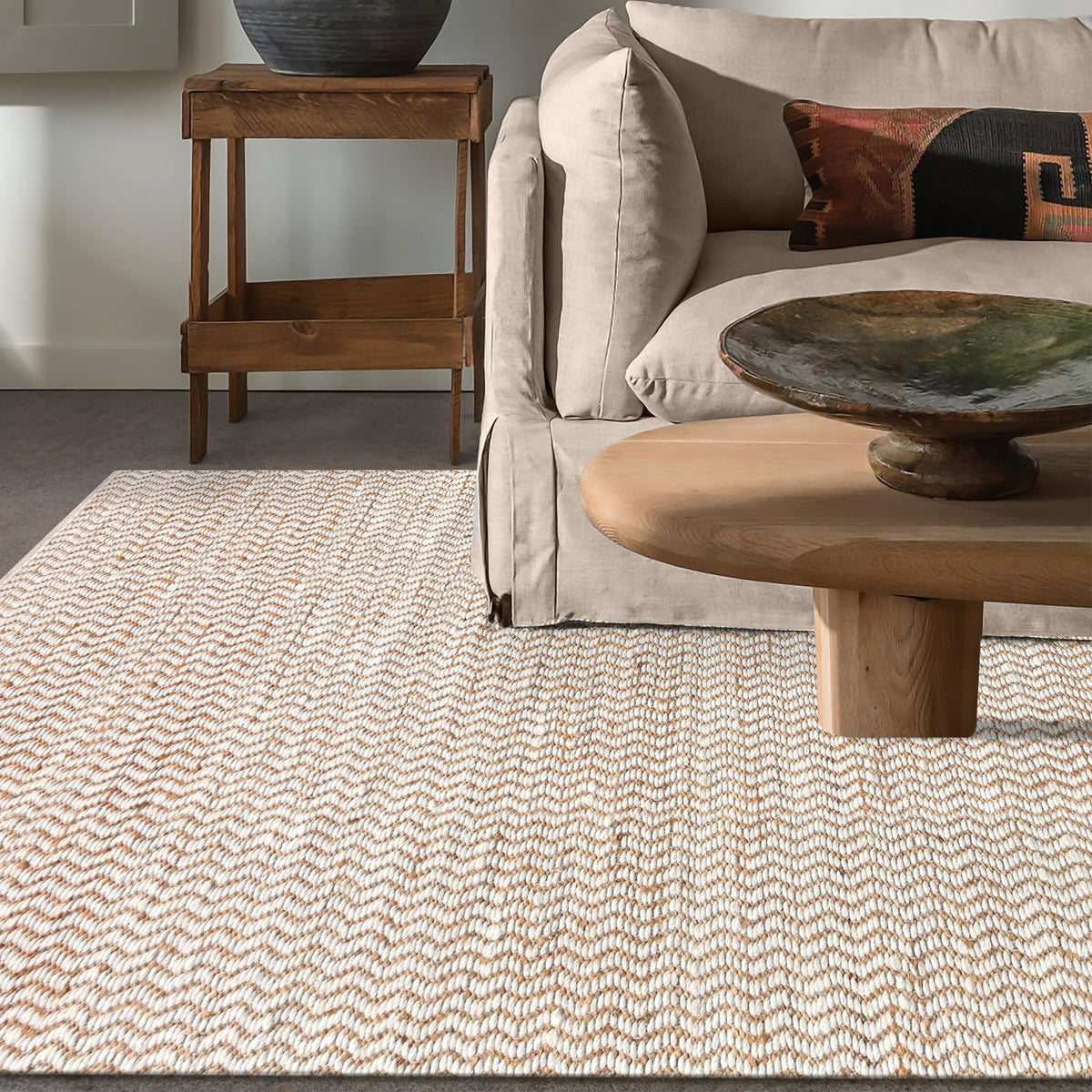 Chevron handwoven cream wool and jute rug with a herringbone chevron weave, in a living room