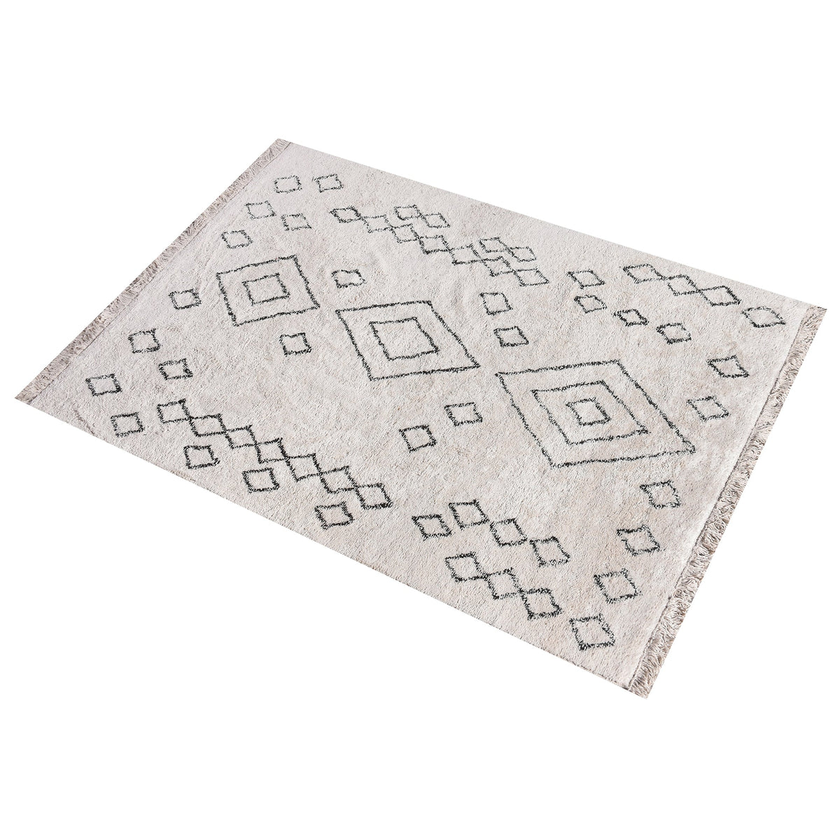 Chhapa tufted cotton rug with black diamonds and chevron borders on bone white, in a study
