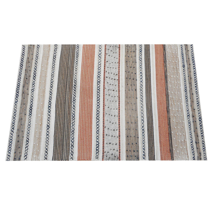 Bunting handwoven hemp and wool rug with horizontal rust, charcoal and ivory stripes, in a study