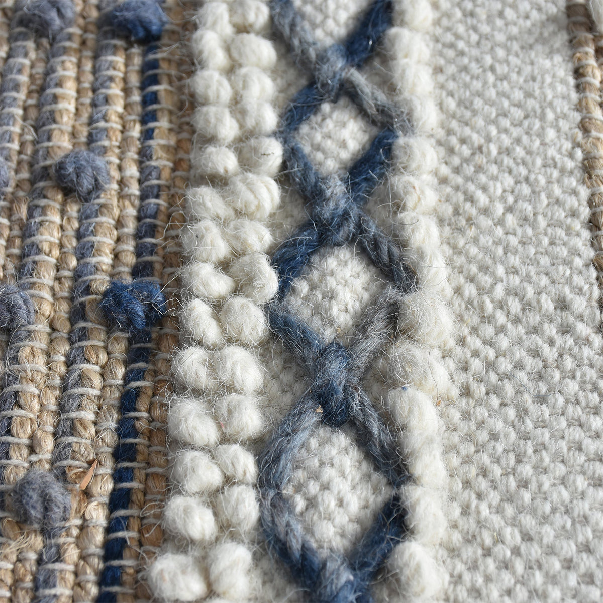 Bunting handwoven hemp and wool rug with horizontal rust, charcoal and ivory stripes, in a study