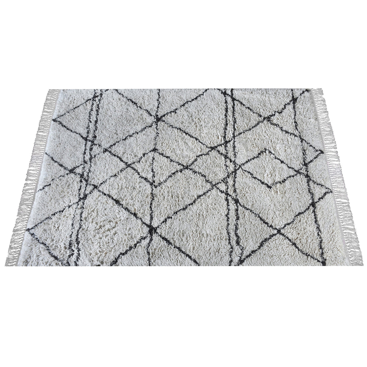 Lipi tufted cotton shag rug in ivory with a bold black lattice, in a bedroom