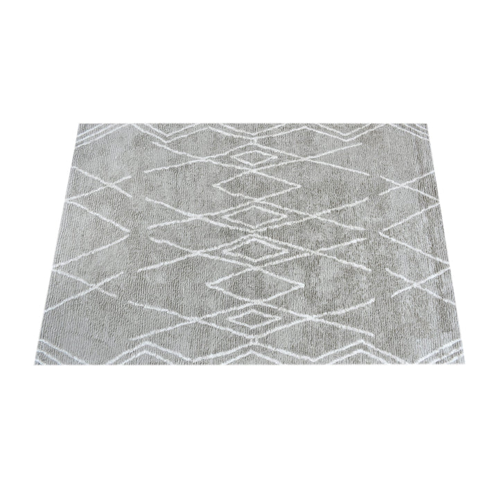 Jugnu tufted cotton and viscose rug with ivory diamond lines on silver grey, in a bedroom