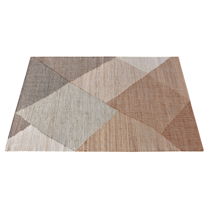 Patang handwoven jute flatweave rug with large blush, tan and grey diamonds, in a bedroom