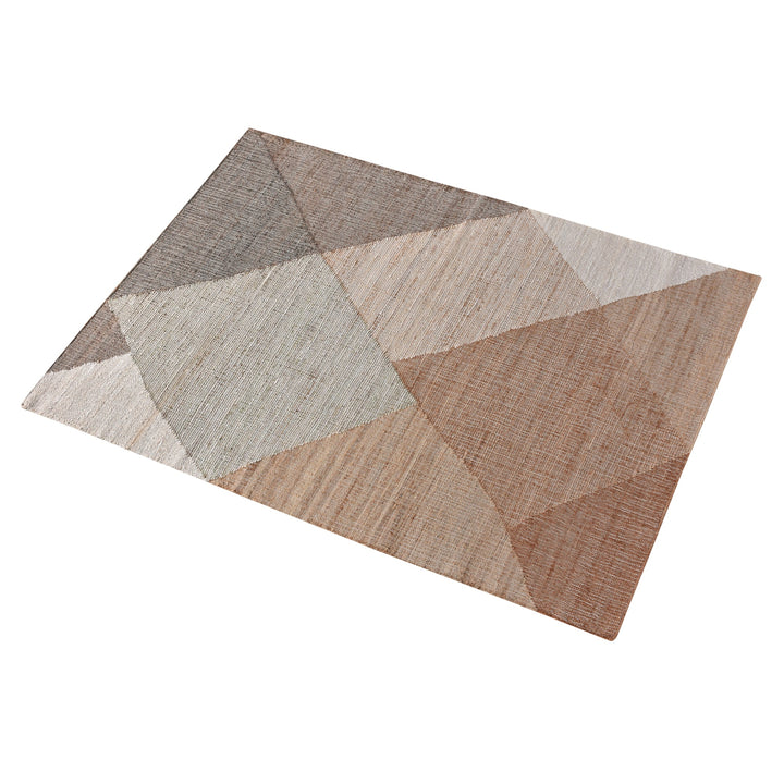 Patang handwoven jute flatweave rug with large blush, tan and grey diamonds, in a bedroom