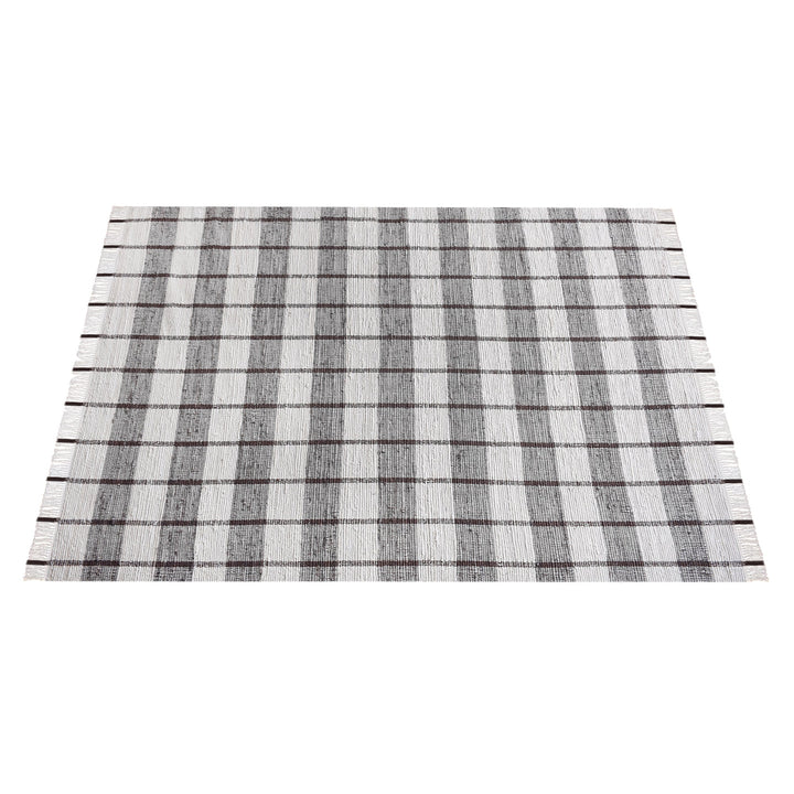 Gamcha handwoven recycled denim flatweave rug with a charcoal-grey and ivory buffalo check, in a living room