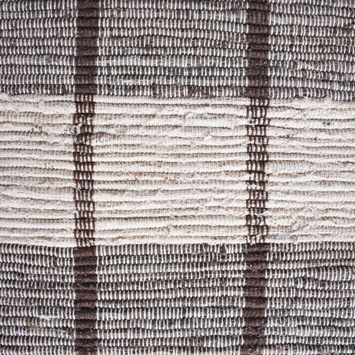 Gamcha handwoven recycled denim flatweave rug with a charcoal-grey and ivory buffalo check, in a living room