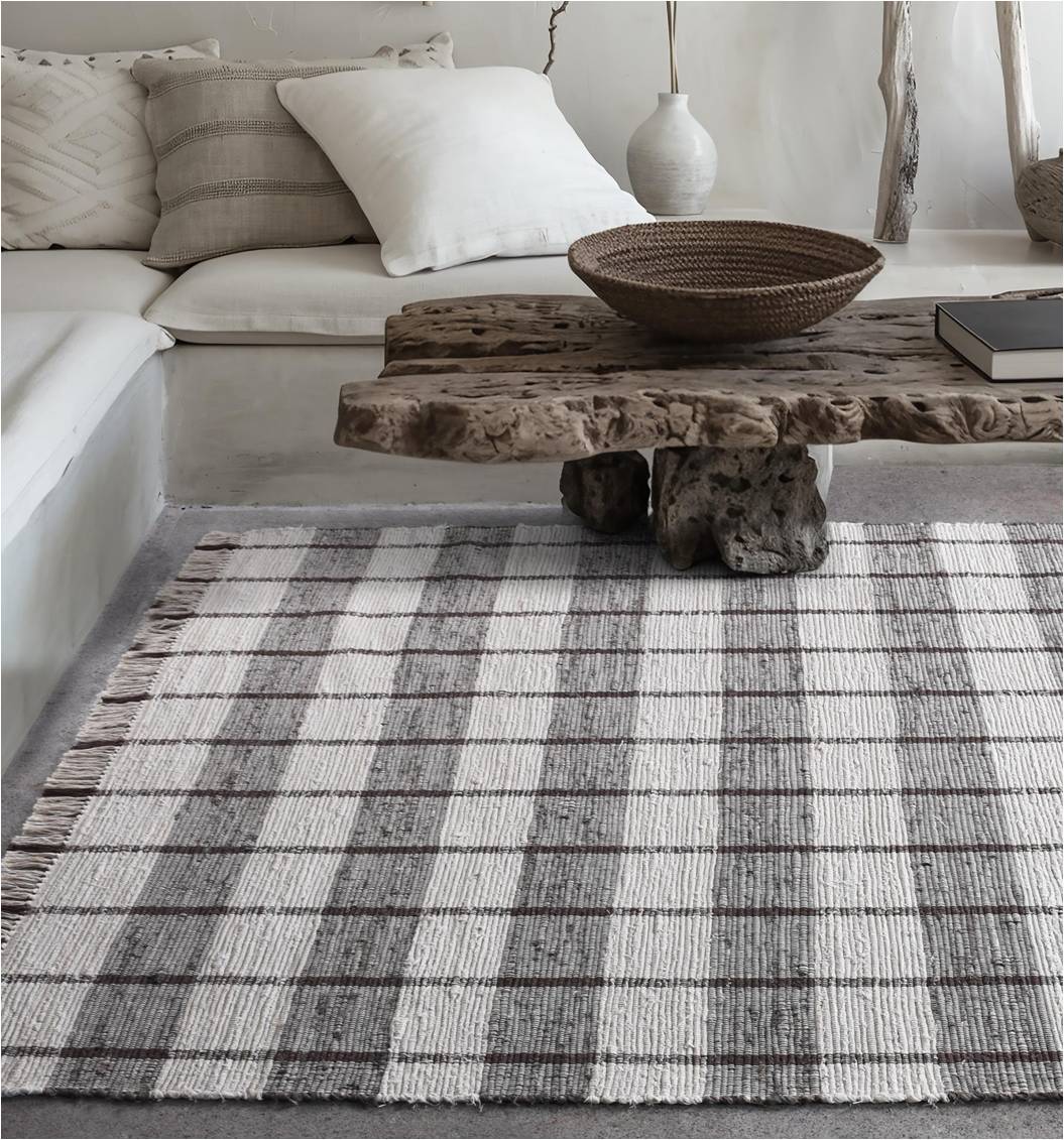 Gamcha handwoven recycled denim flatweave rug with a charcoal-grey and ivory buffalo check, in a living room