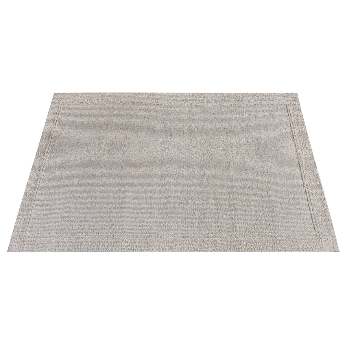 Linen handwoven wool rug in plain cream with a tonal border, in a bedroom