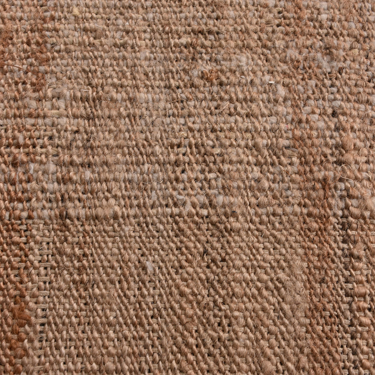 Sunbaked flatweave jute and wool rug in terracotta and blush colour blocks, in a living room