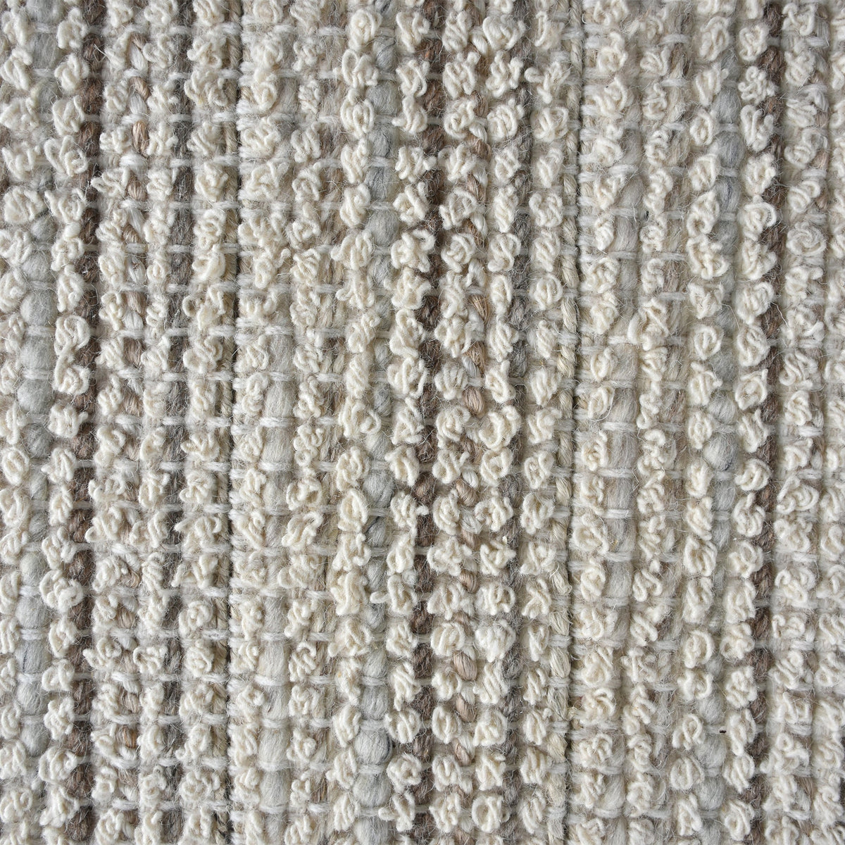 Kinara handwoven wool and jute rug in ivory and beige stripes, in a living room