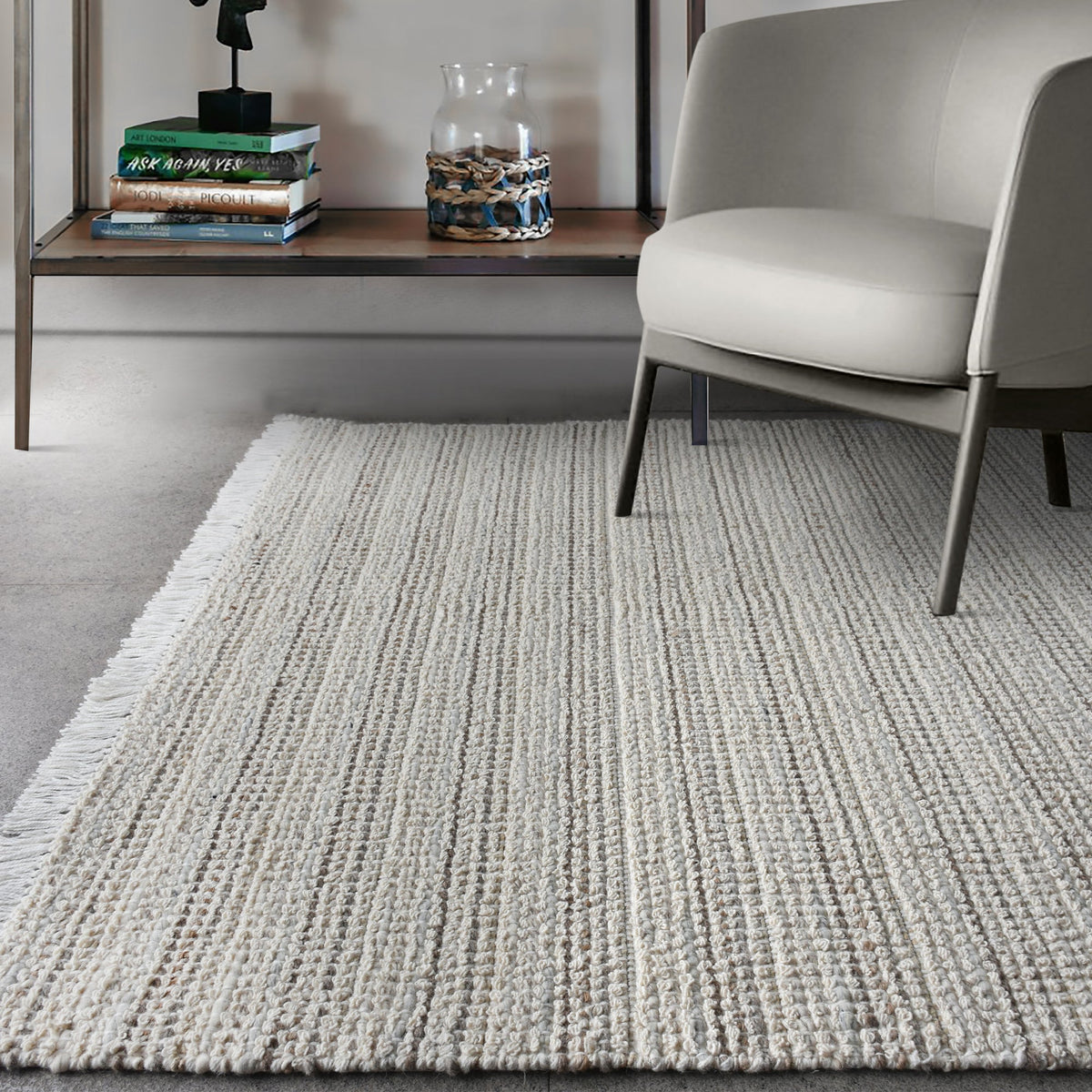 Kinara handwoven wool and jute rug in ivory and beige stripes, in a living room