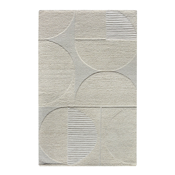 Archway handwoven ivory wool rug with carved arc lines, in a living room