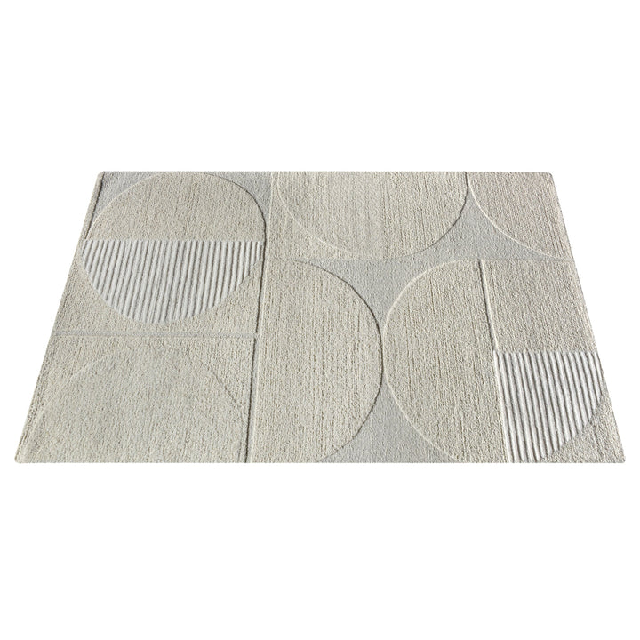 Archway handwoven ivory wool rug with carved arc lines, in a living room
