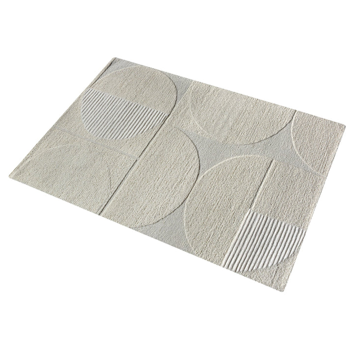 Archway handwoven ivory wool rug with carved arc lines, in a living room