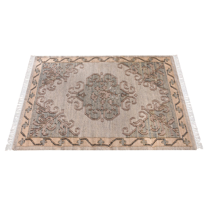 Haveli handwoven flatweave jute and wool rug with a faded beige medallion and terracotta border, in a living room
