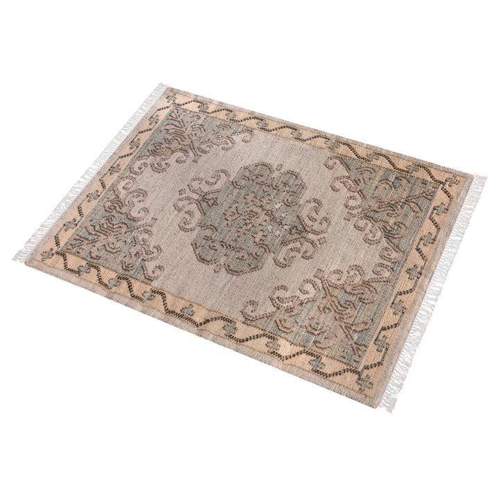 Haveli handwoven flatweave jute and wool rug with a faded beige medallion and terracotta border, in a living room