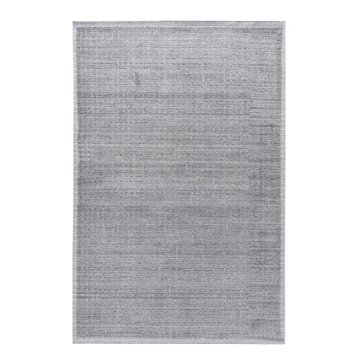 Raakh handwoven flatweave recycled PET rug in plain heather grey with fringe, in a living room
