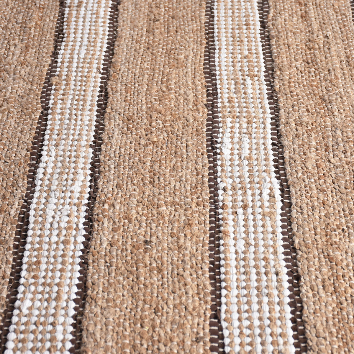 Hessian handwoven hemp and leather rug with ivory stripes on tan, in a dining room