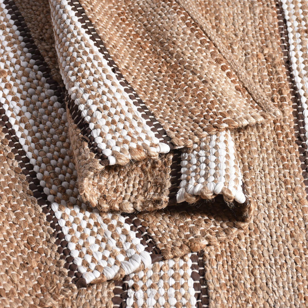 Hessian handwoven hemp and leather rug with ivory stripes on tan, in a dining room