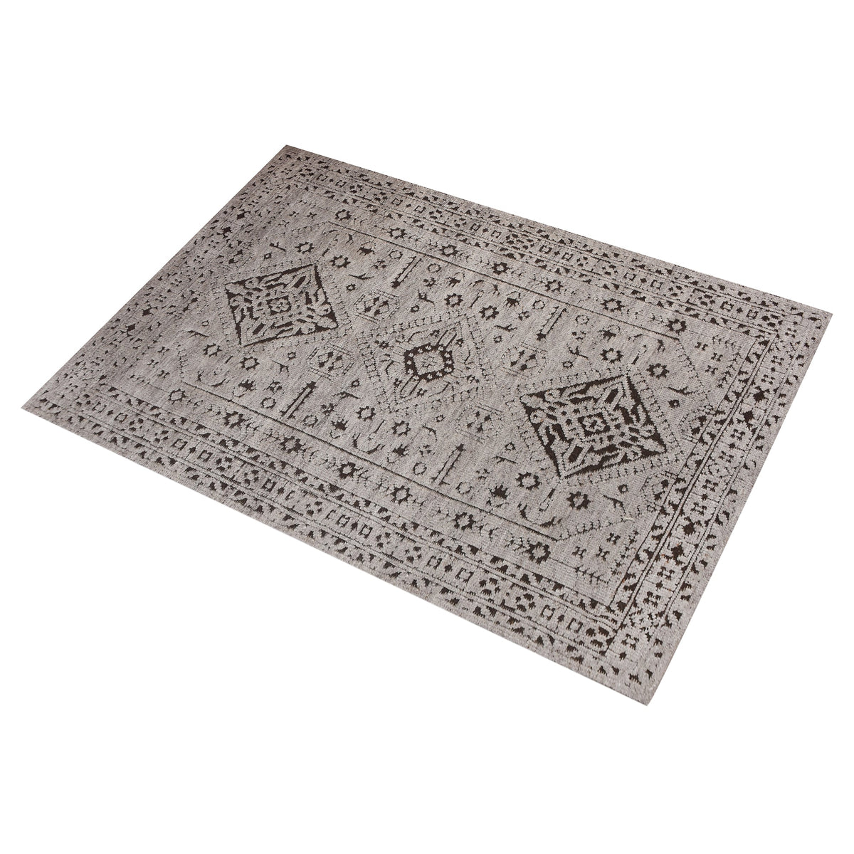 Inkwell hand-knotted ivory wool rug with a faded black tribal medallion, in a living room