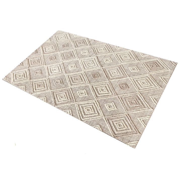 Jaali handwoven oatmeal wool rug with raised ivory diamond lattice, in a living room