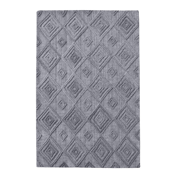 Jaali handwoven oatmeal wool rug with raised ivory diamond lattice, in a living room