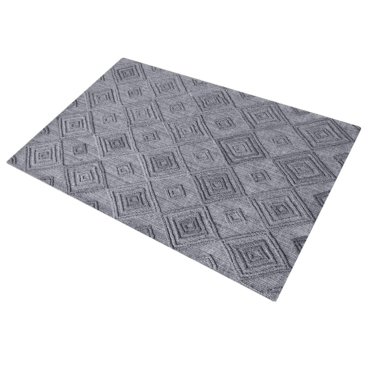 Jaali handwoven oatmeal wool rug with raised ivory diamond lattice, in a living room