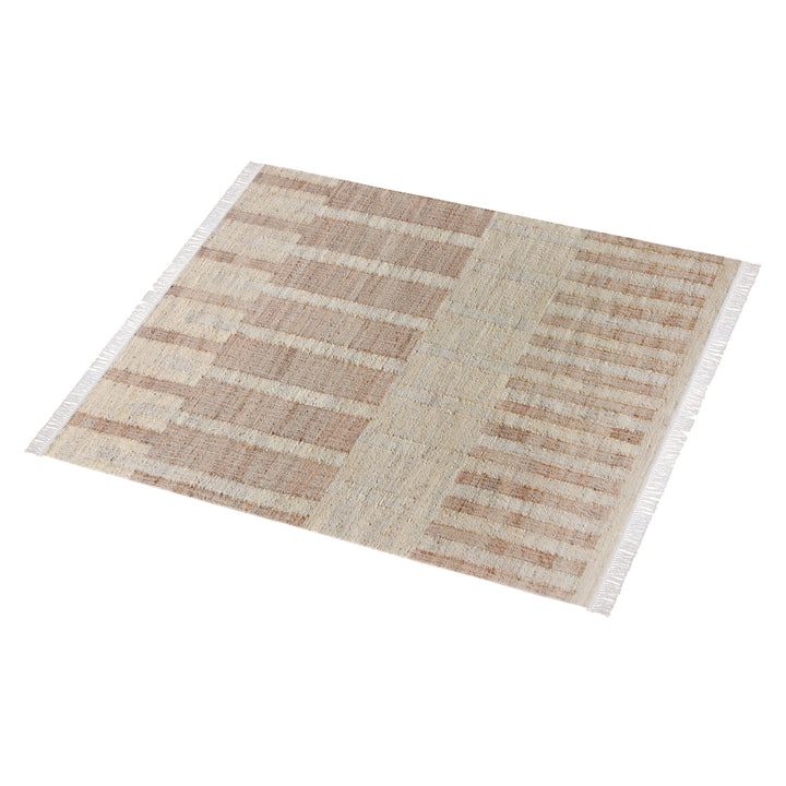 Diwar handwoven jute flatweave rug in natural, blush and ivory blocks, in a living room