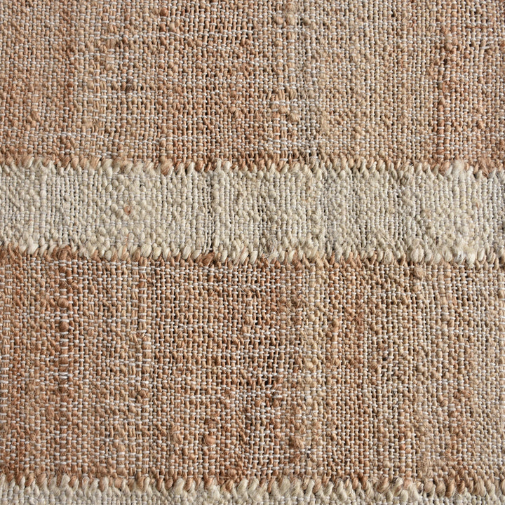 Diwar handwoven jute flatweave rug in natural, blush and ivory blocks, in a living room