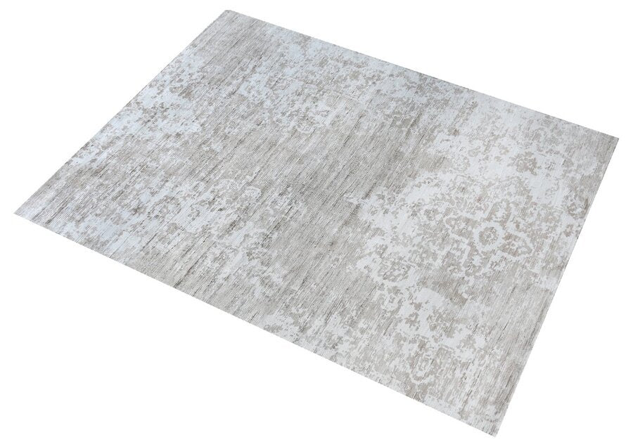 Parchhai handwoven viscose rug with an erased medallion on pale silver beige, in a living room