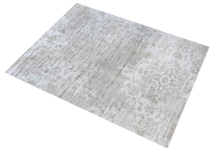 Parchhai handwoven viscose rug with an erased medallion on pale silver beige, in a living room