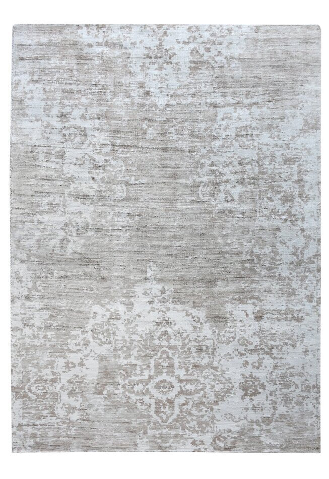 Parchhai handwoven viscose rug with an erased medallion on pale silver beige, in a living room